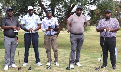 Game faces on: NetOne golfers await their moment on the tee.