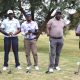 Game faces on: NetOne golfers await their moment on the tee.