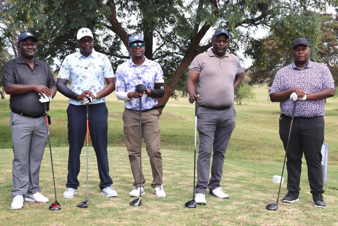 Game faces on: NetOne golfers await their moment on the tee.